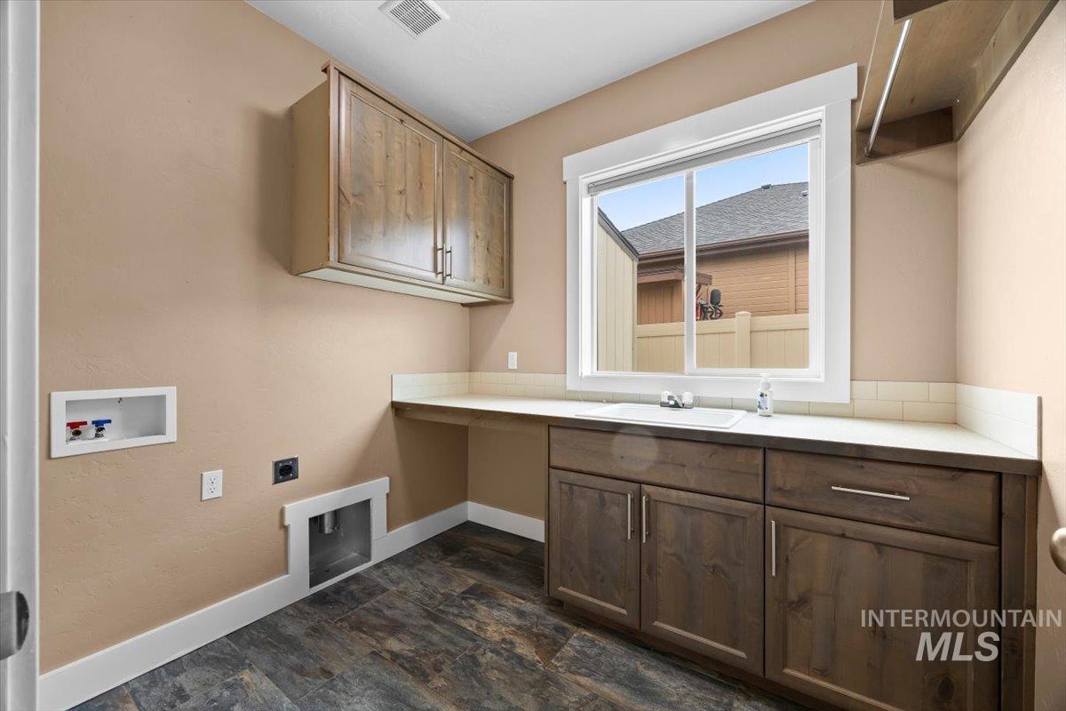 13557 Signorello Street Caldwell, ID 83607 - Photo 16 of 30 Laundry room featuring cabinet space, washer hookup, and electric dryer hookup