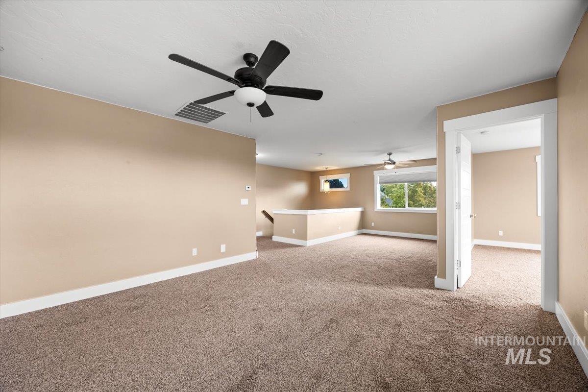 13557 Signorello Street Caldwell, ID 83607 - Photo 24 of 30 Unfurnished room featuring light colored carpet and baseboards