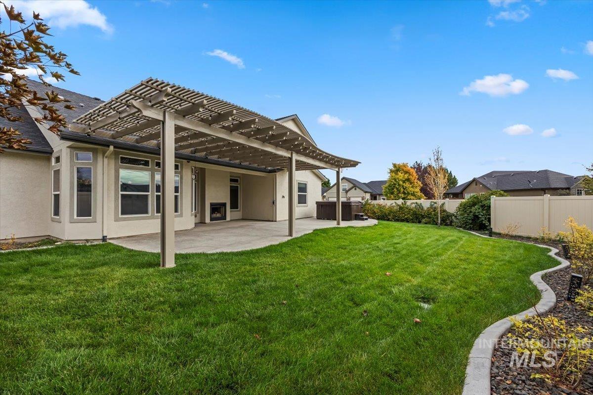 13557 Signorello Street Caldwell, ID 83607 - Photo 29 of 30 Back of house with a pergola, stucco siding, a fenced backyard, and a patio area