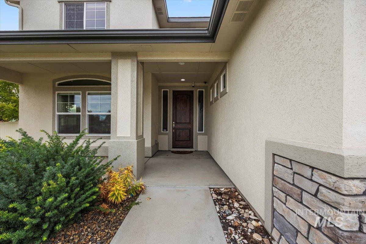 13557 Signorello Street Caldwell, ID 83607 - Photo 3 of 30 Property entrance with stucco siding and covered porch
