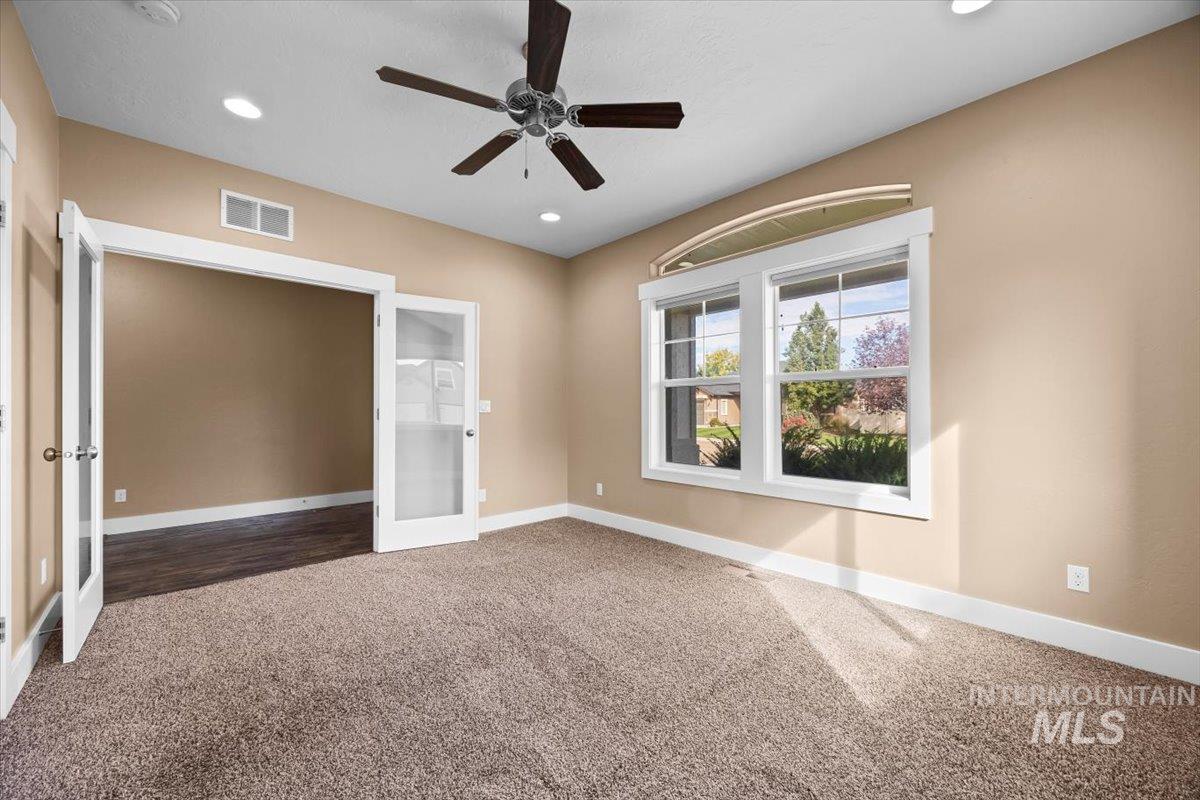 13557 Signorello Street Caldwell, ID 83607 - Photo 4 of 30 Unfurnished bedroom with carpet, recessed lighting, a ceiling fan, and french doors