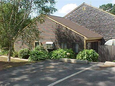 a view of a house with a yard and a garden