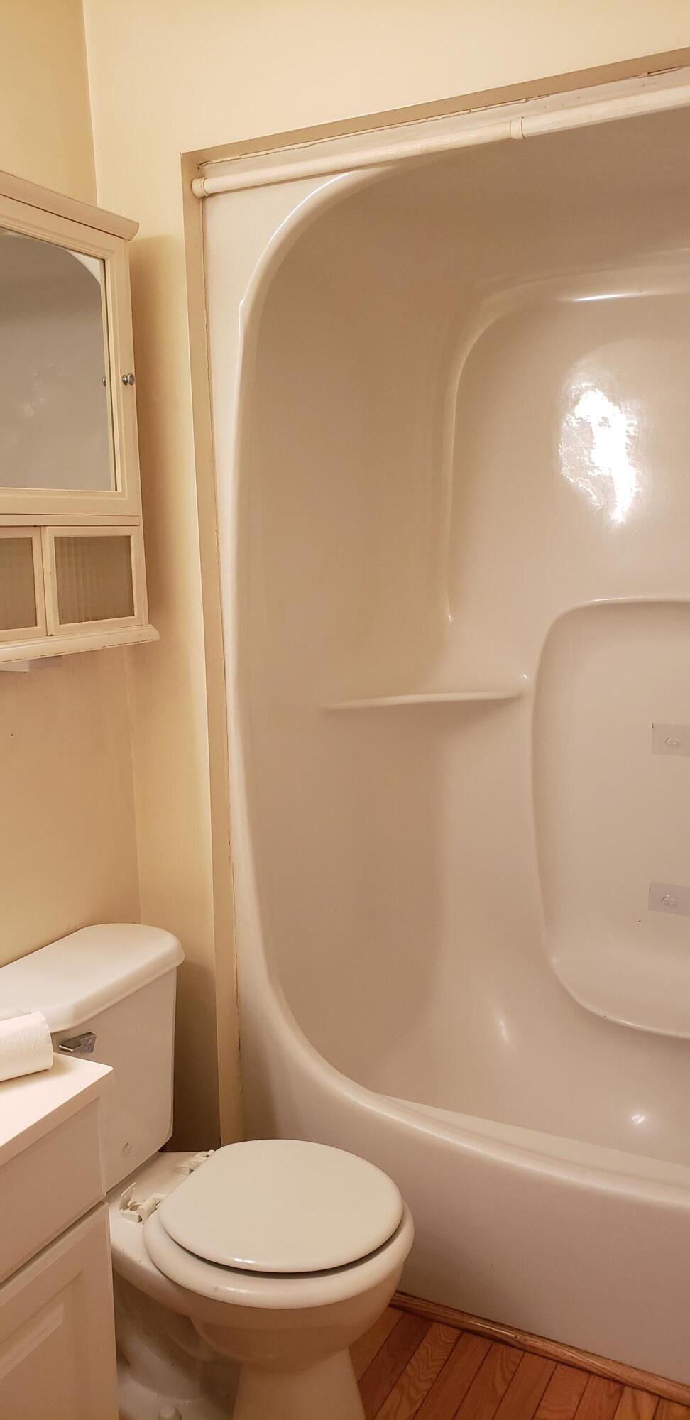 38 Round House Road, Unit 38 Bourne, MA 02532 - Photo 5 of 8 a white toilet sitting next to a bath tub
