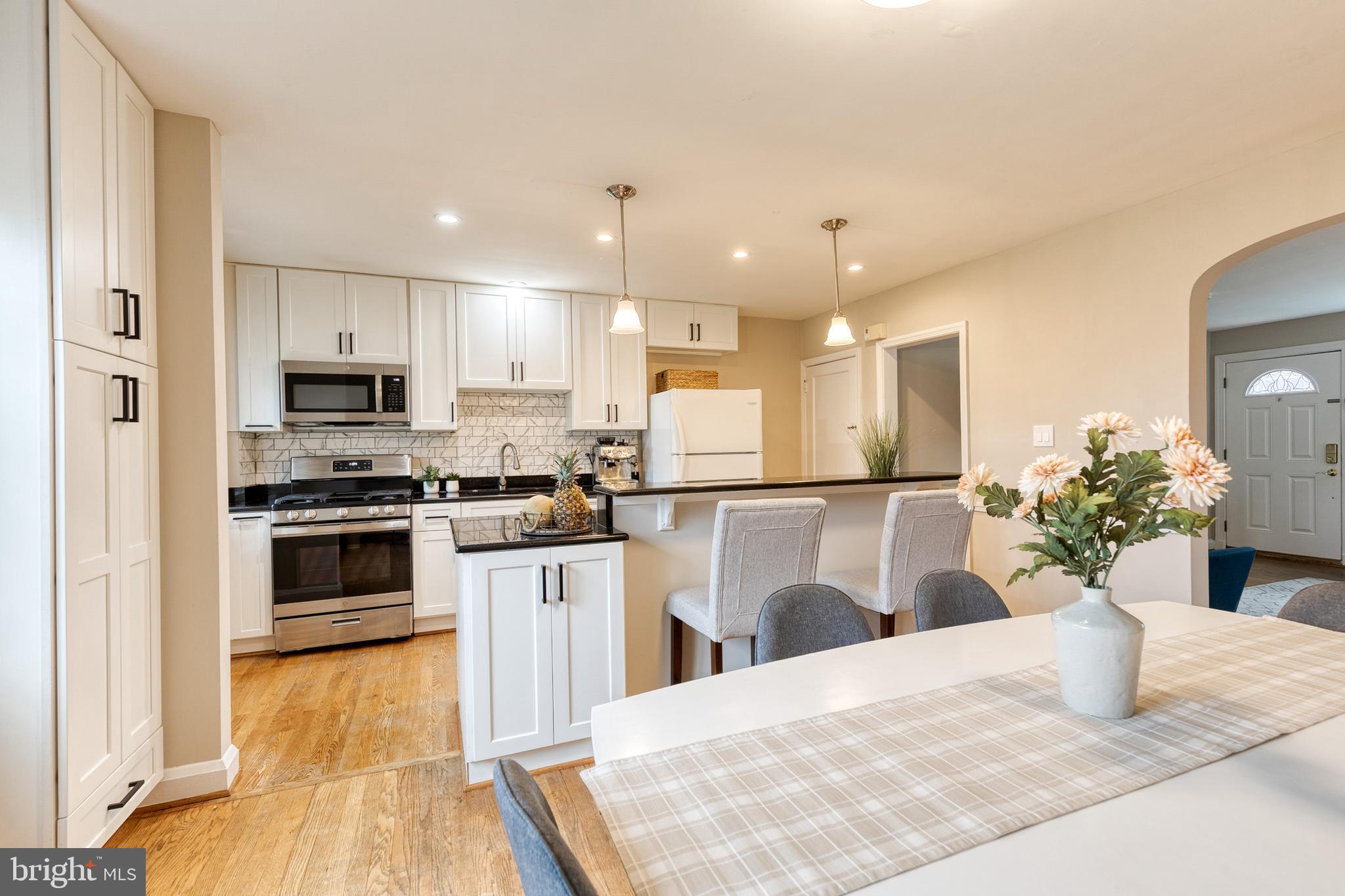 31 Regester Avenue Baltimore, MD 21212 - Photo 13 of 38 a kitchen with refrigerator a microwave and cabinets