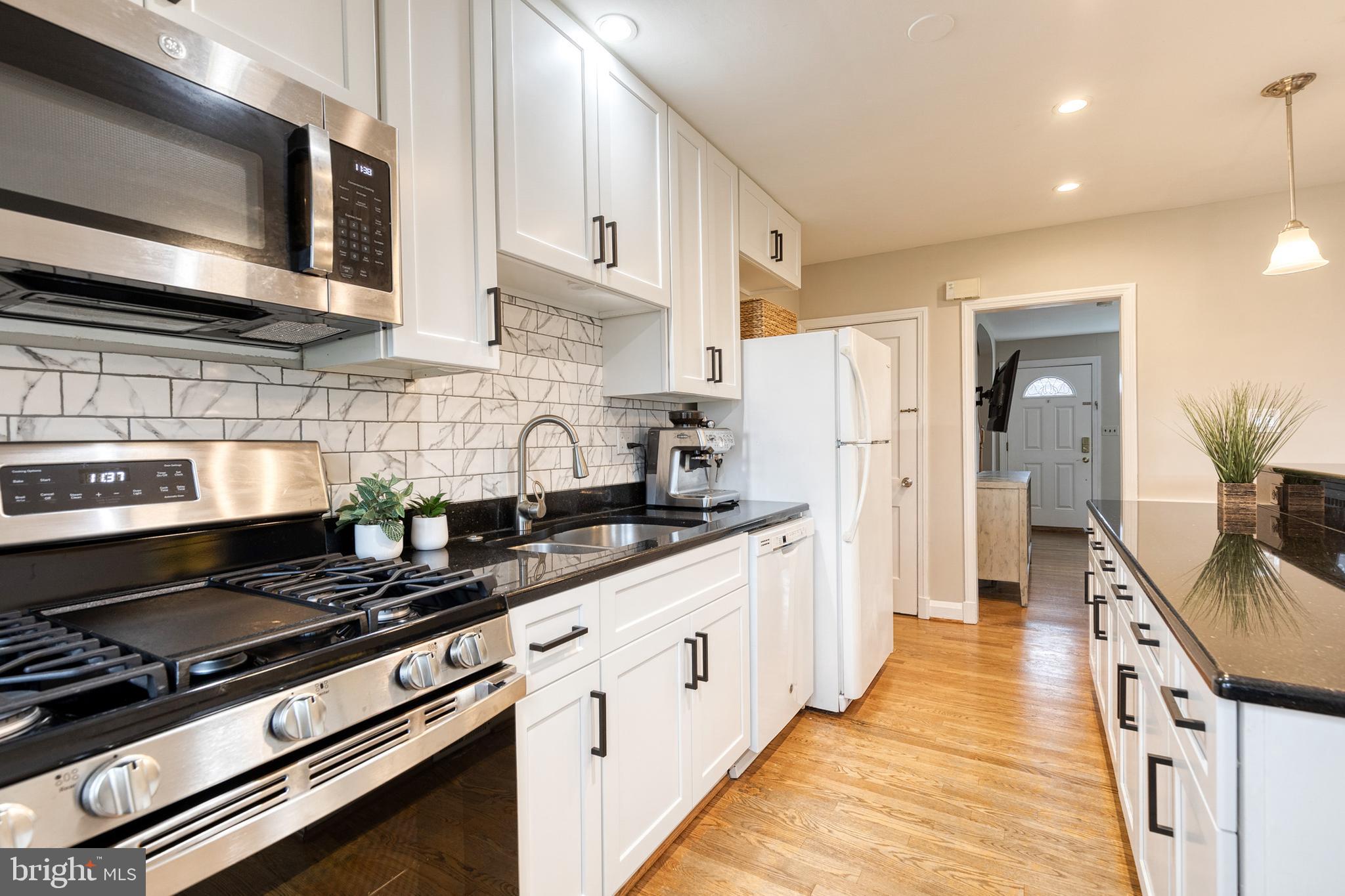 31 Regester Avenue Baltimore, MD 21212 - Photo 20 of 38 a kitchen with stainless steel appliances a stove microwave and refrigerator