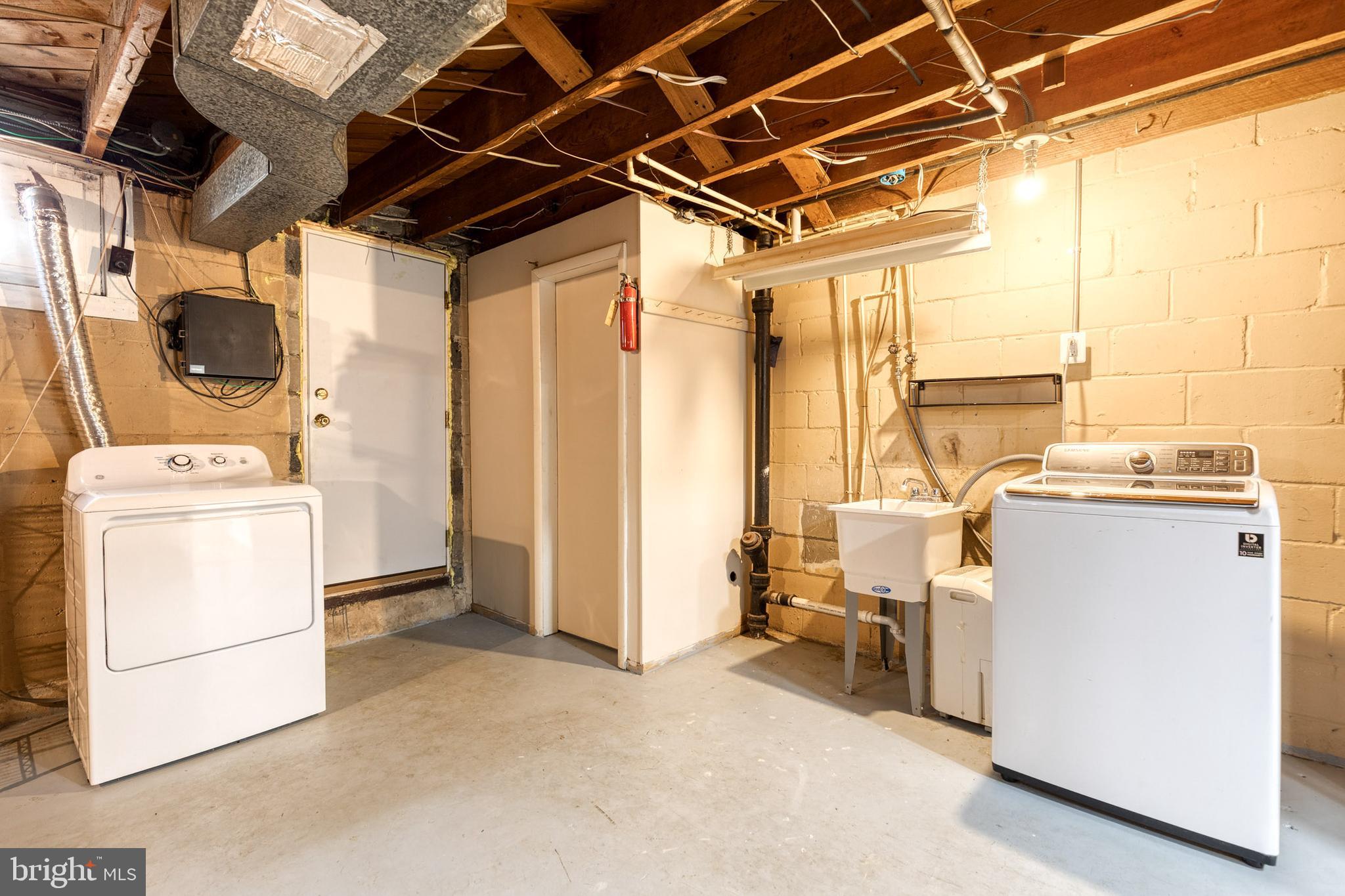 31 Regester Avenue Baltimore, MD 21212 - Photo 26 of 38 a view of storage and utility room with washer and dryer