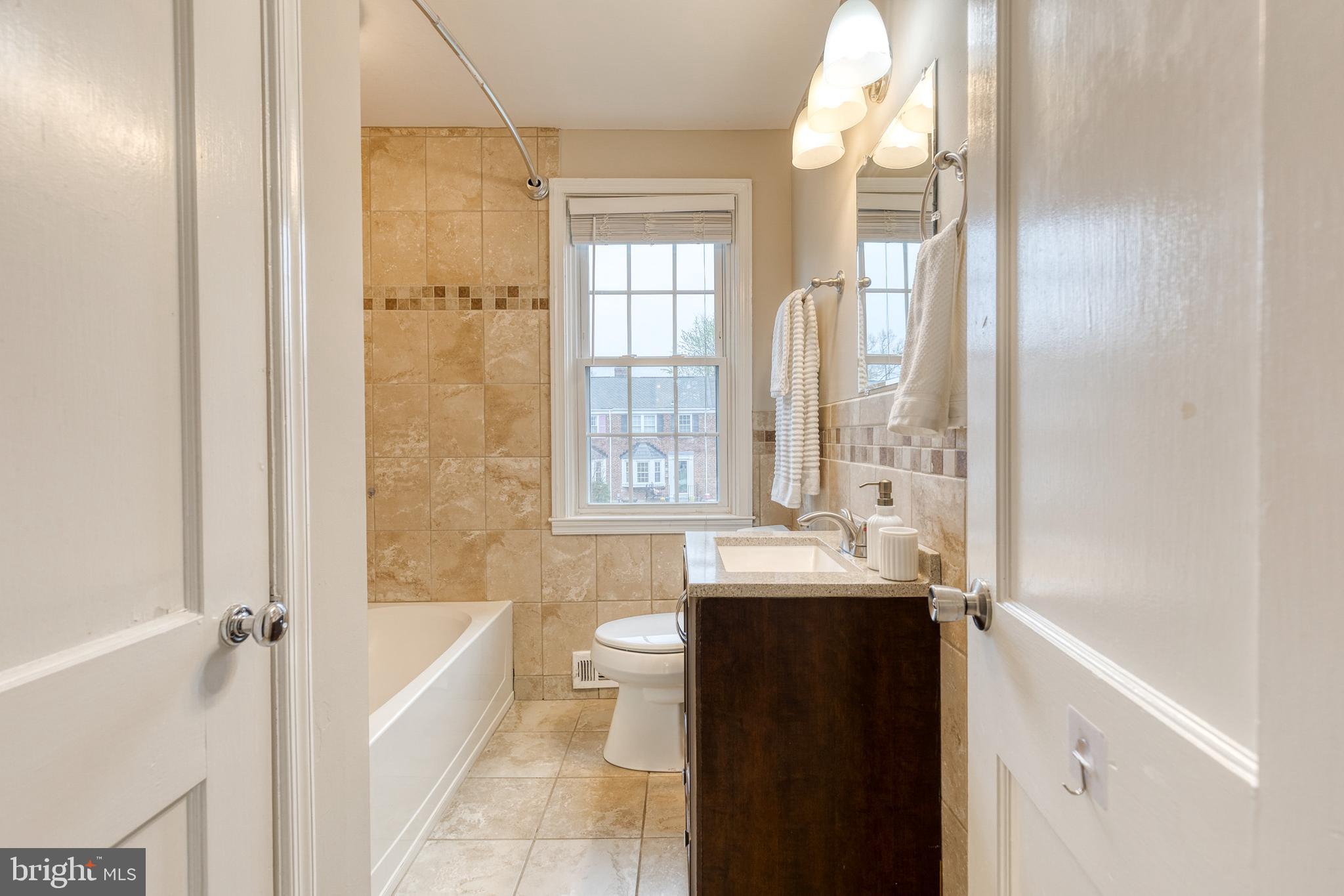 31 Regester Avenue Baltimore, MD 21212 - Photo 32 of 38 a bathroom with a tub sink and mirror