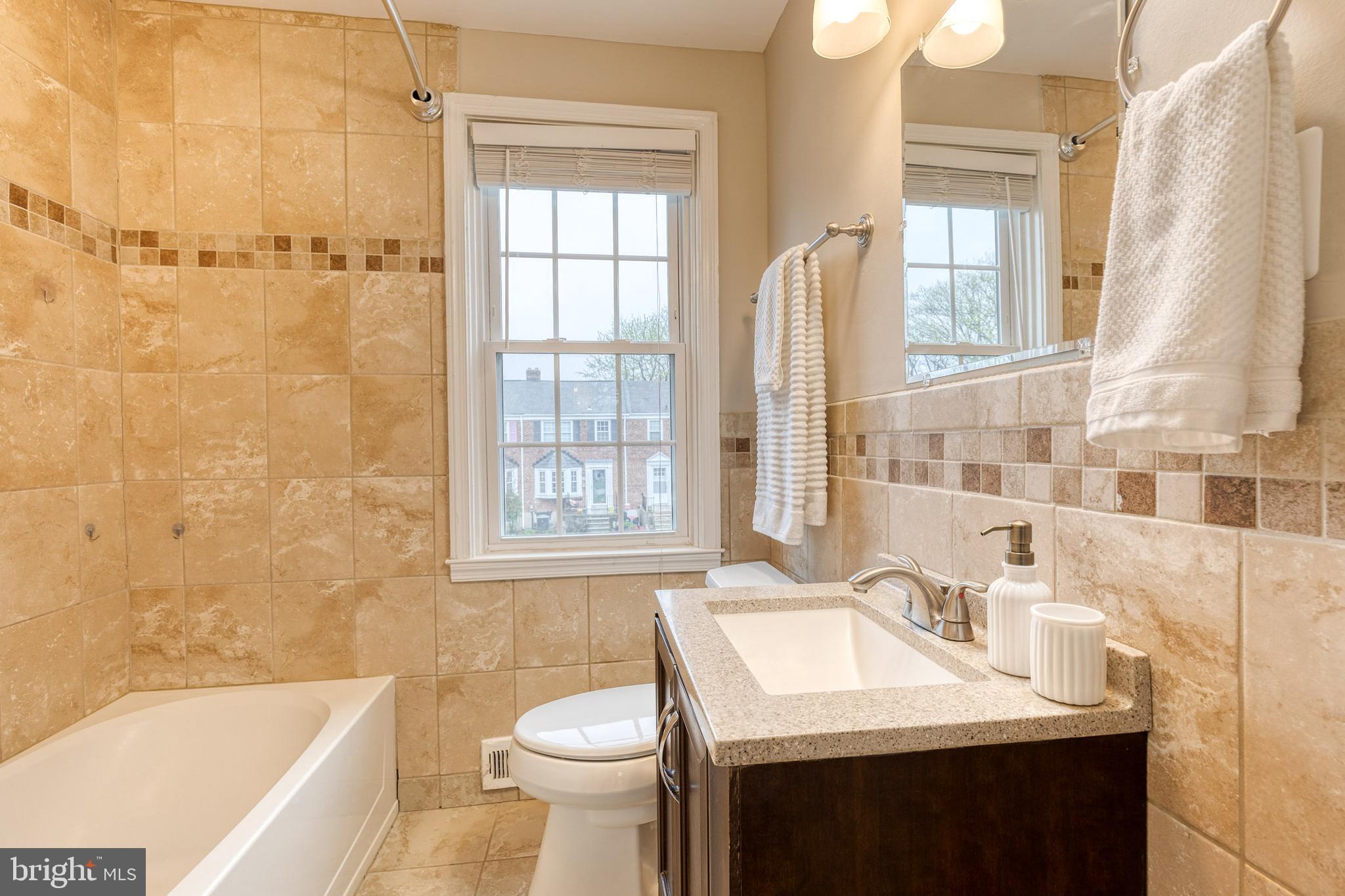 31 Regester Avenue Baltimore, MD 21212 - Photo 33 of 38 a bathroom with a sink toilet and shower