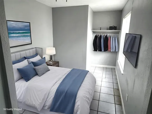 a bedroom with a bed and walk in closet