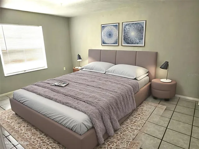 a bedroom with a bed and a window