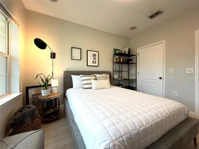 a bedroom with a bed and a window