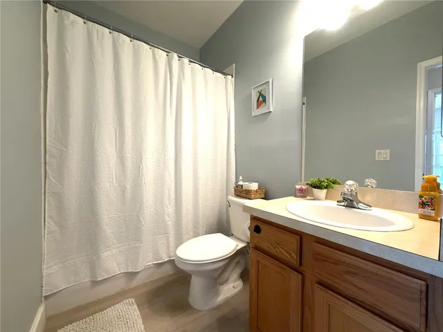 a bathroom with a sink a toilet and a mirror