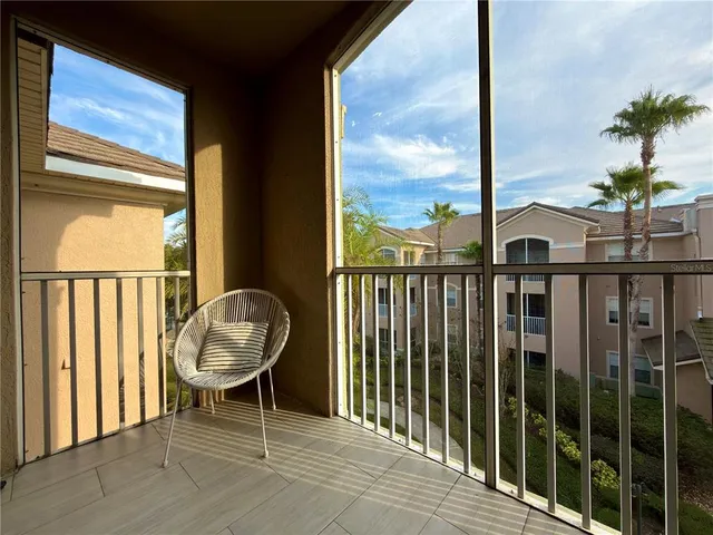 a view of a balcony with chair and table