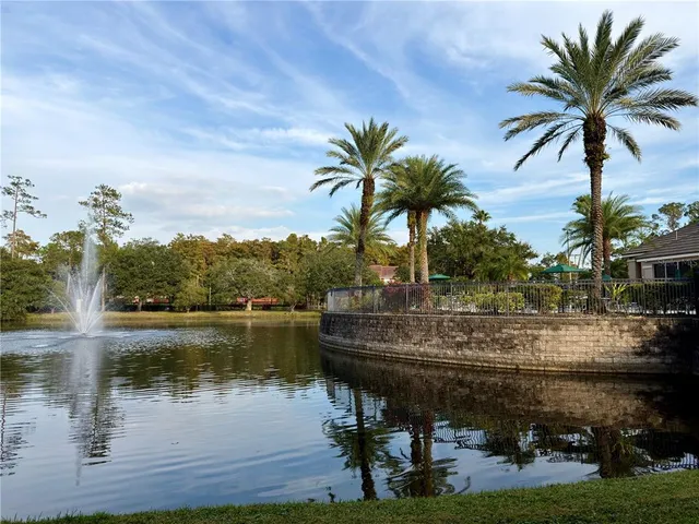 a view of lake with a table and chairs in the patio