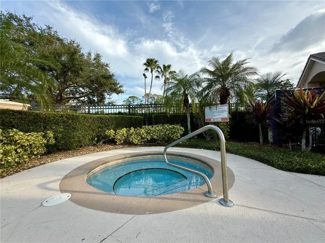 a view of a swimming pool with a yard and plants