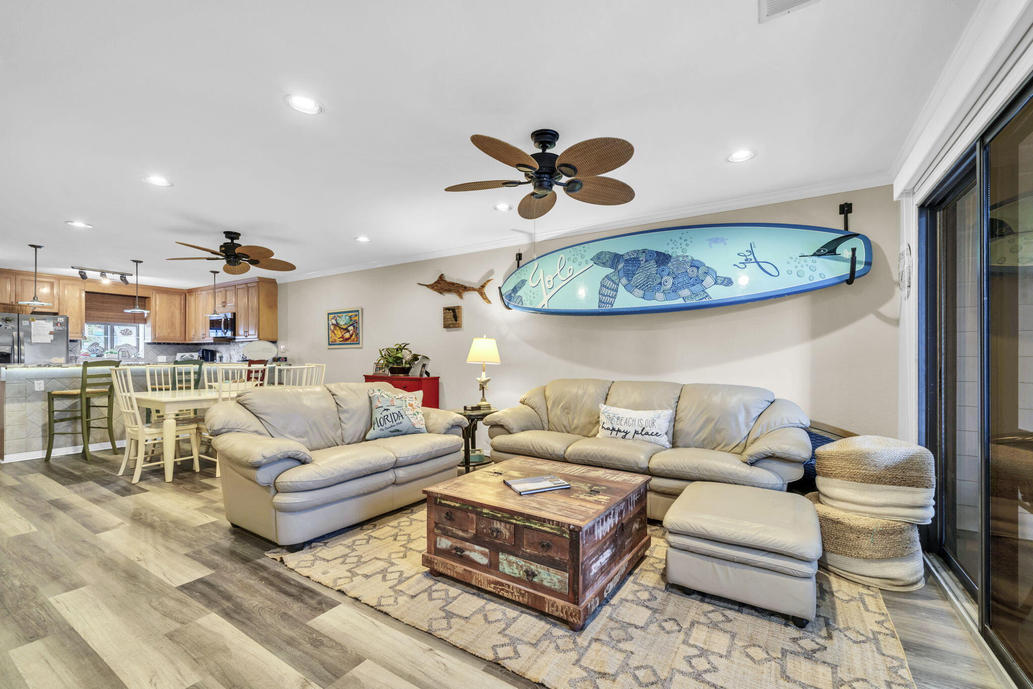 a living room with furniture a ceiling fan and a rug