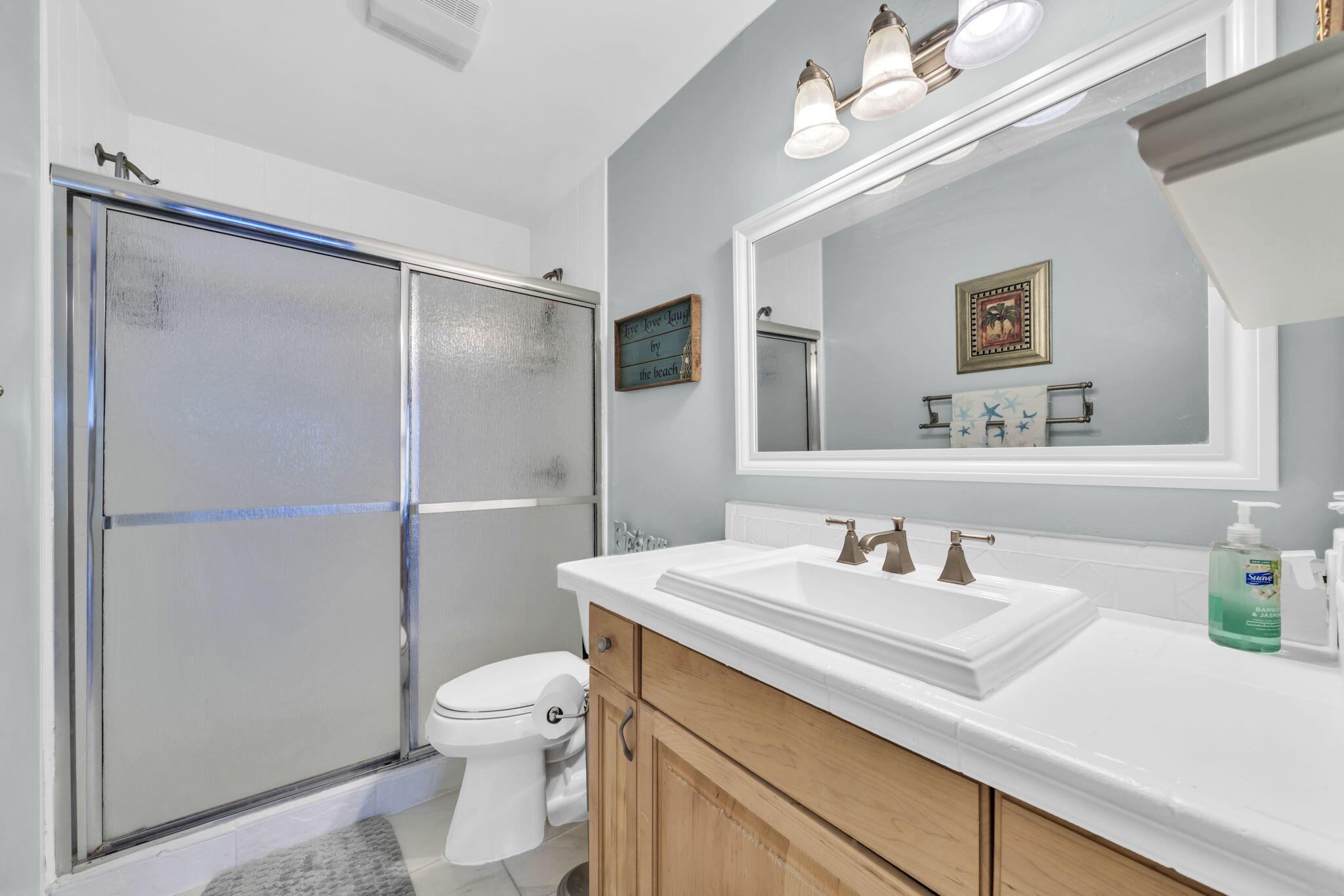 288 Ellis Road, Unit 114 Miramar Beach, FL 32550 - Photo 24 of 30 a bathroom with a sink a toilet a mirror and shower