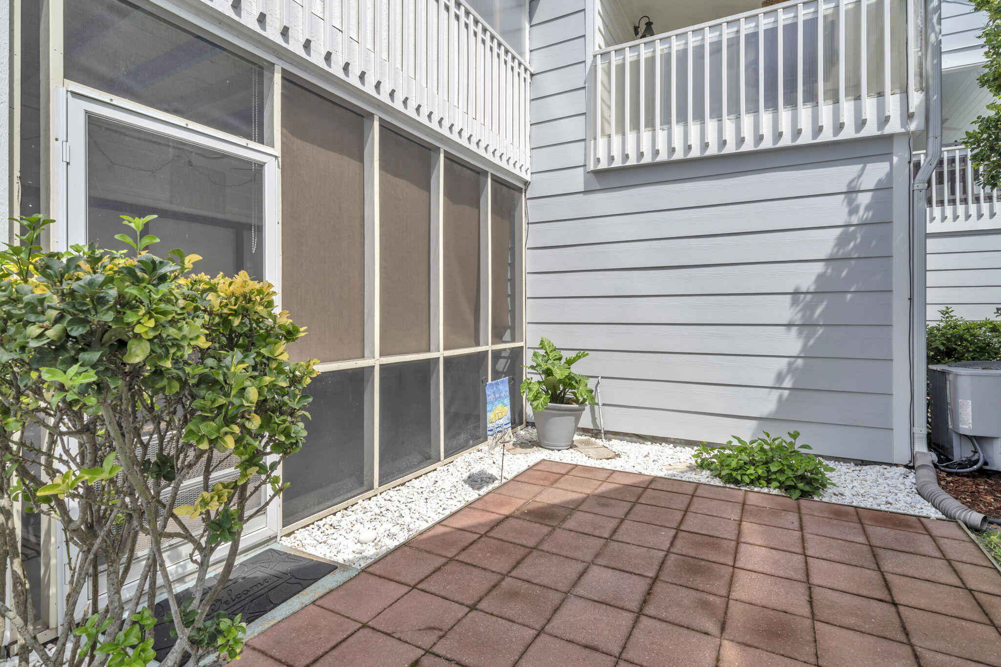 288 Ellis Road, Unit 114 Miramar Beach, FL 32550 - Photo 26 of 30 a potted plant sitting in front of a house