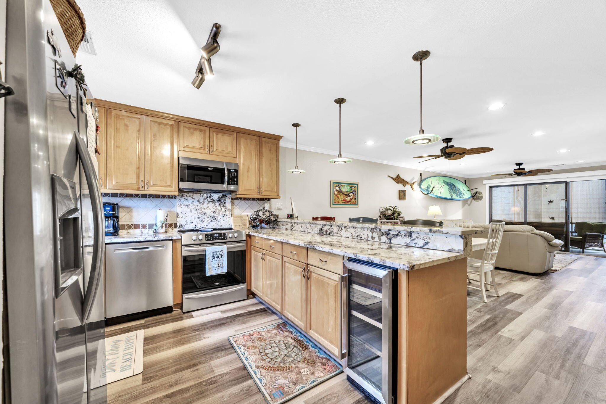 288 Ellis Road, Unit 114 Miramar Beach, FL 32550 - Photo 4 of 30 a kitchen with kitchen island granite countertop a stove top oven a sink a counter space and cabinets