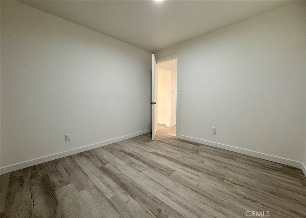 1362 South Downey Road Los Angeles, CA 90023 - Photo 20 of 30 an empty room with wooden floor and windows
