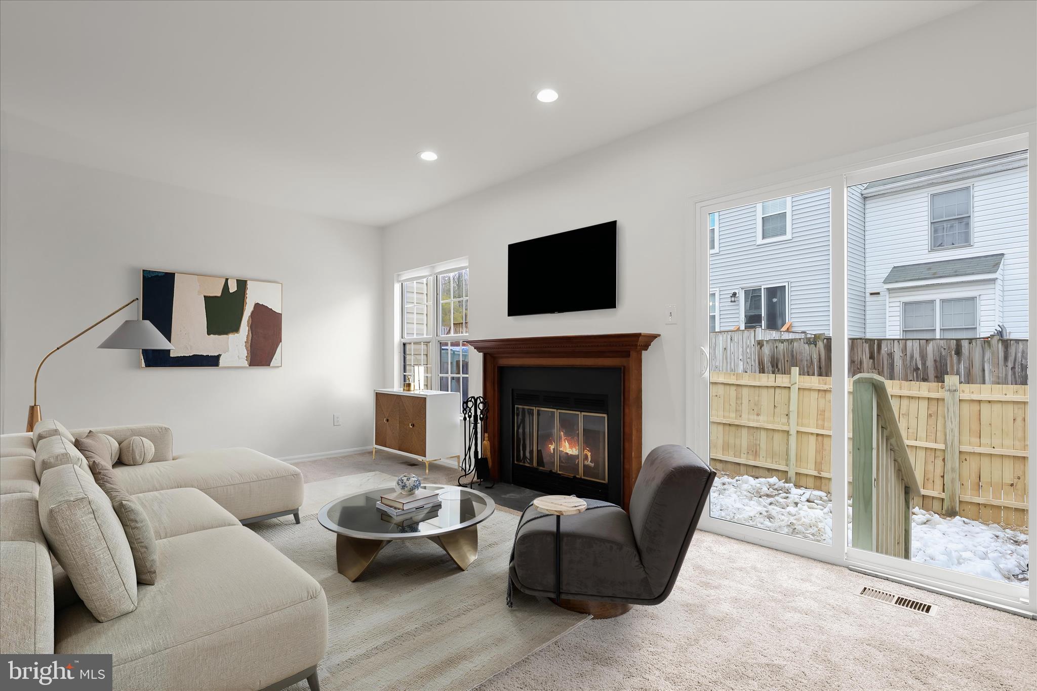 508 Greencrest Lane Odenton, MD 21113 - Photo 12 of 46 a living room with furniture a flat screen tv and a fireplace