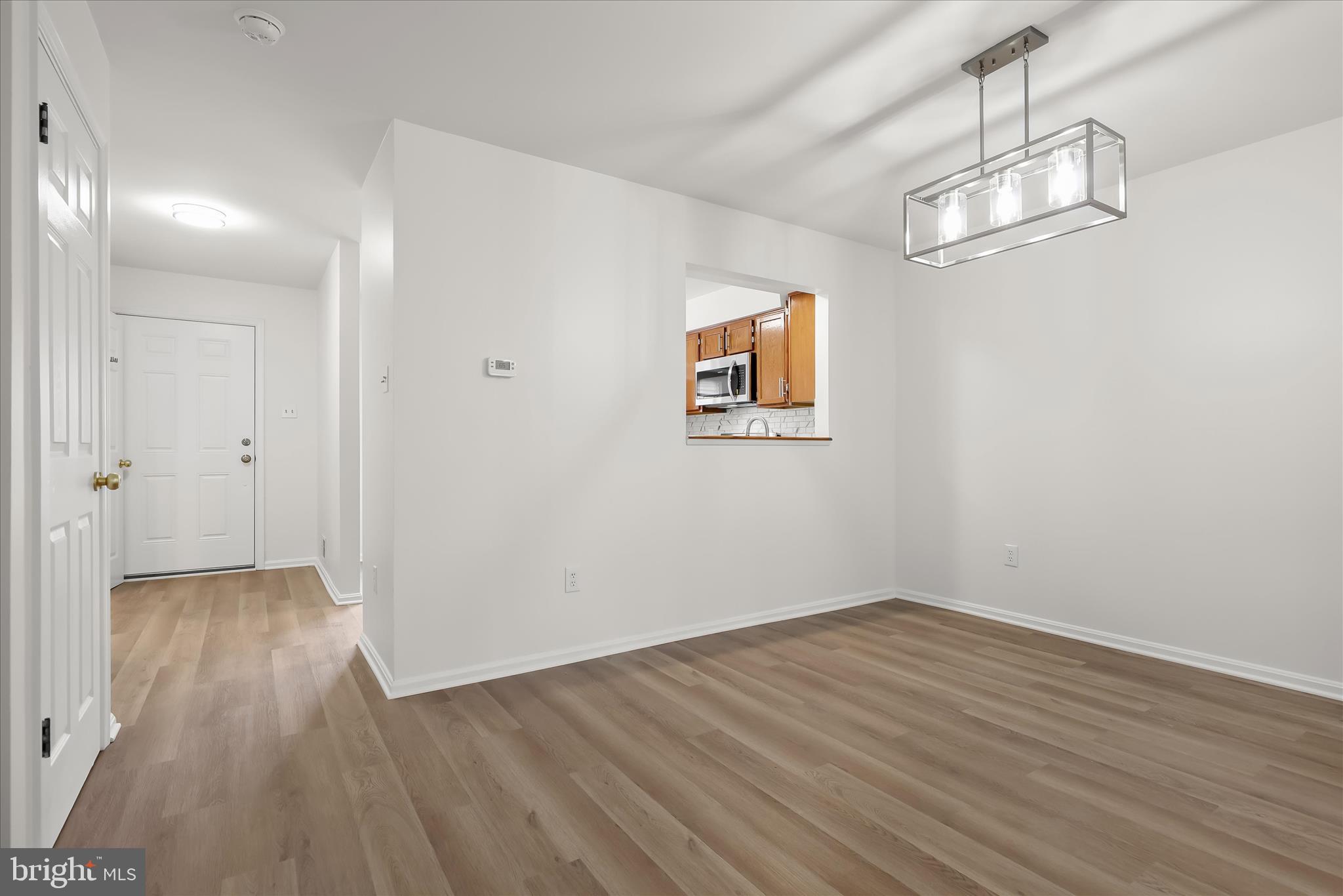 508 Greencrest Lane Odenton, MD 21113 - Photo 13 of 46 wooden floor in an empty room with a window