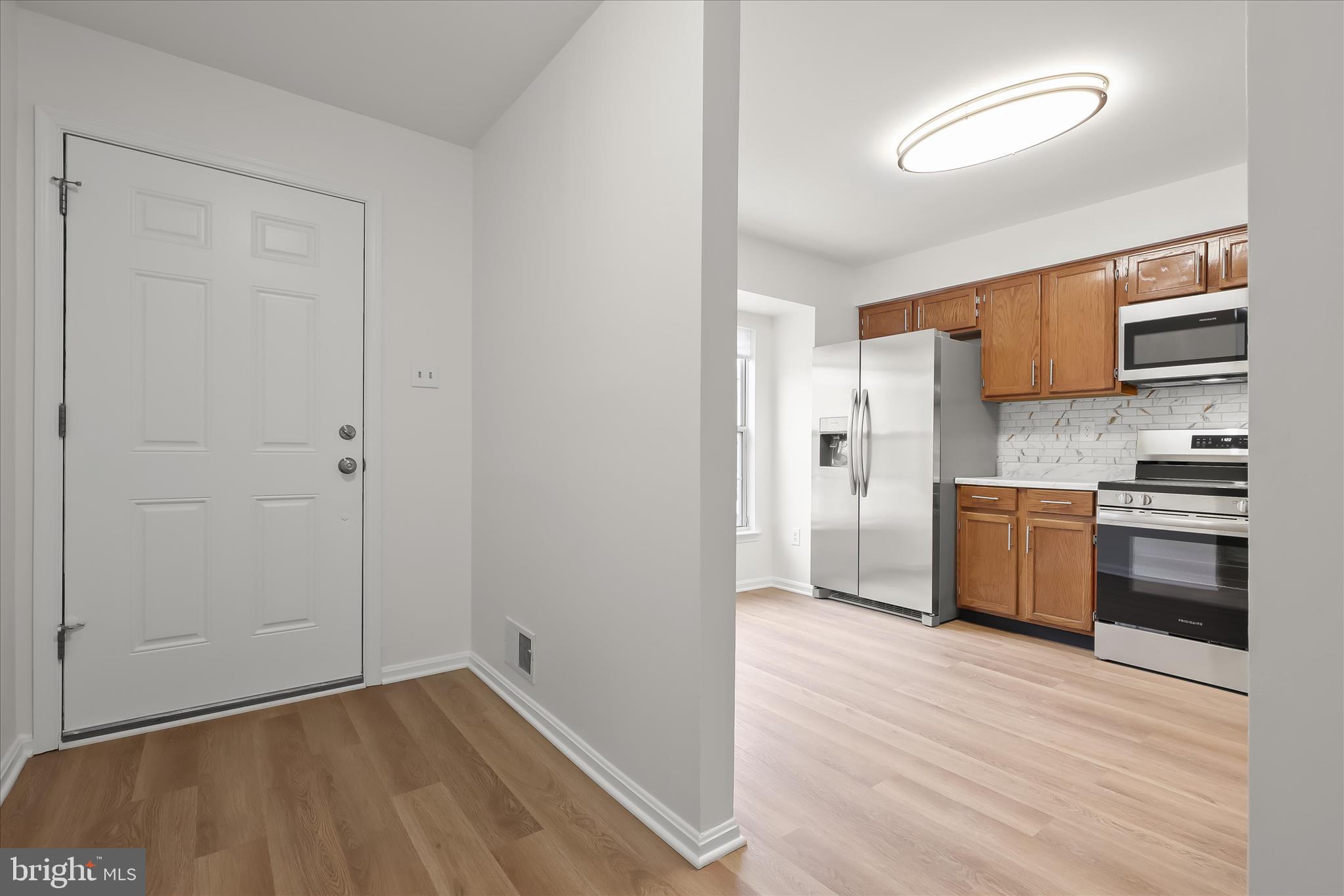 508 Greencrest Lane Odenton, MD 21113 - Photo 2 of 46 a kitchen with a refrigerator and a stove top oven