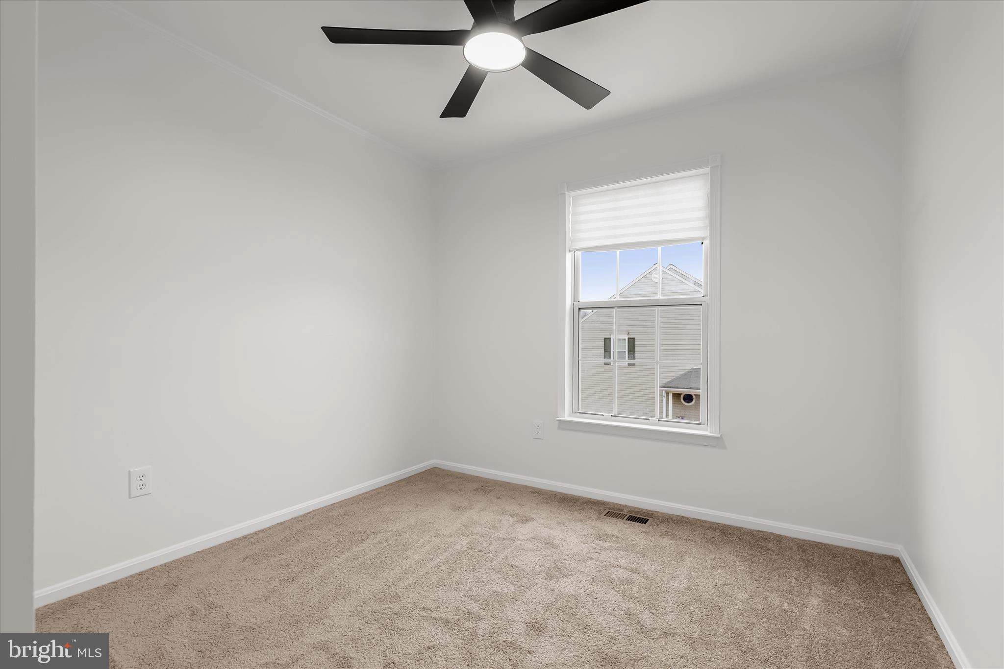 508 Greencrest Lane Odenton, MD 21113 - Photo 28 of 46 an empty room with a window and a ceiling fan