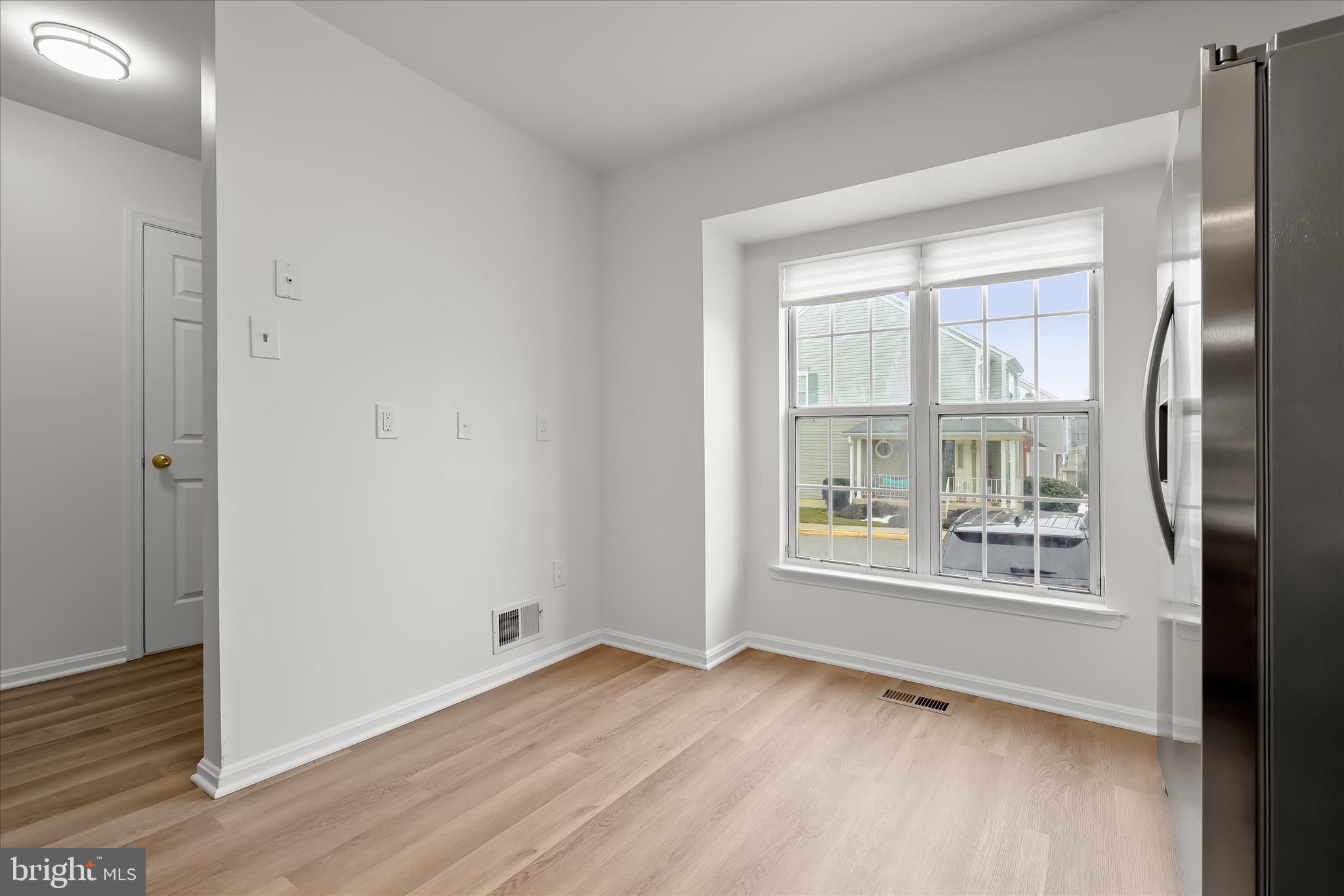 508 Greencrest Lane Odenton, MD 21113 - Photo 7 of 46 an empty room with wooden floor and windows
