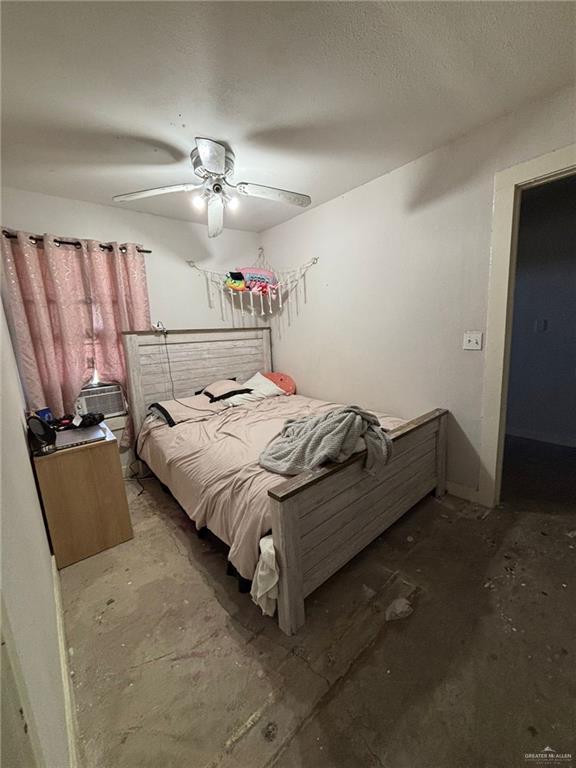 6806 Navaho Street Mission, TX 78572 - Photo 12 of 15 a bedroom with a bed and a ceiling fan