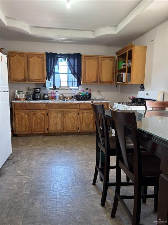 6806 Navaho Street Mission, TX 78572 - Photo 4 of 15 a kitchen with a table chairs sink and cabinets