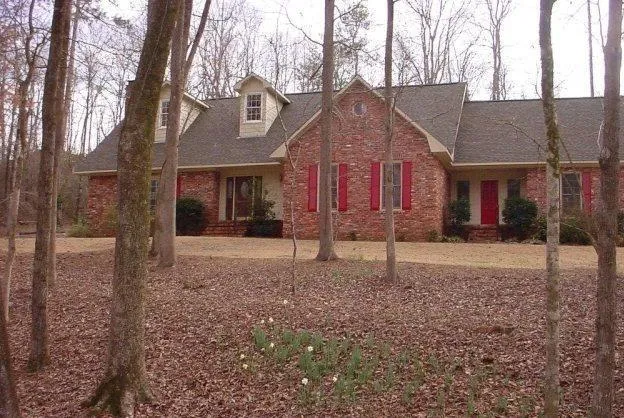 a house that has a tree in front of it