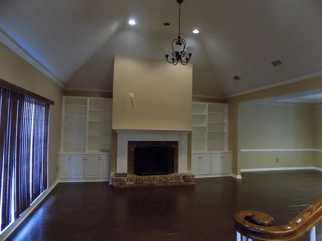 a view of a livingroom with a fireplace and window