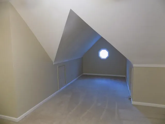 a view of a chandelier fan in an empty room