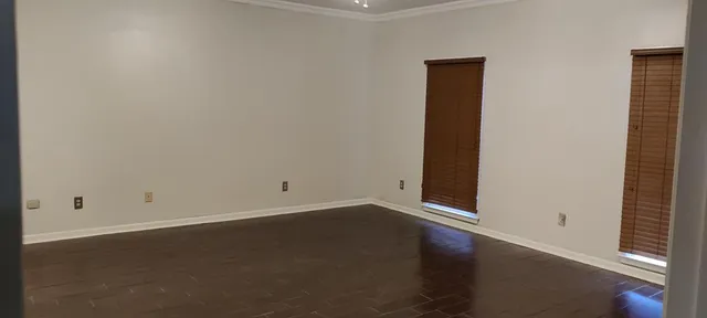 an empty room with closet and fan