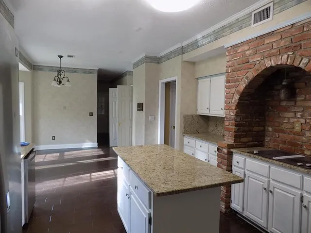 a kitchen with granite countertop a sink and a stove