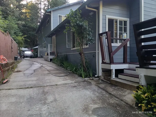 a view of a house with a yard and pathway