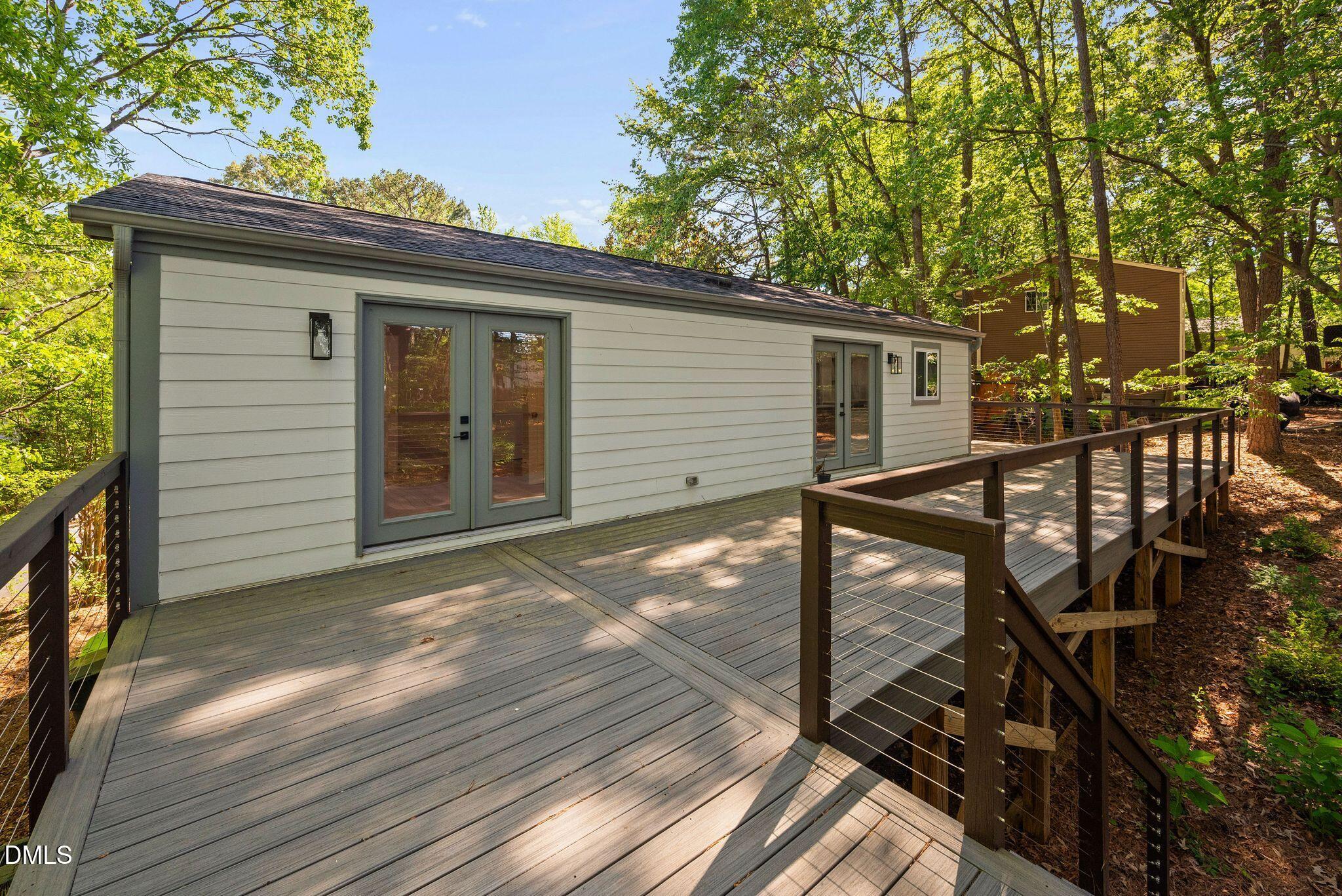 313 Crown Oaks Drive Raleigh, NC 27615 - Photo 34 of 60 a view of a house with a large window and wooden fence