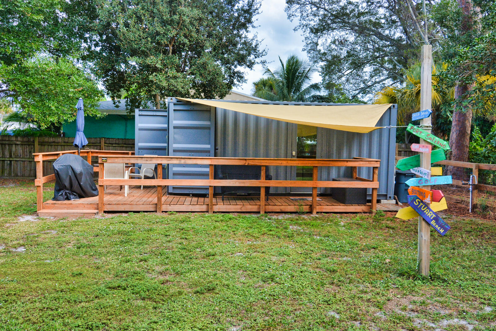 a backyard of a house with childrens swing and slide table and chairs
