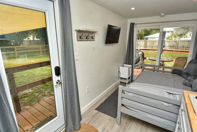 a view of room with wooden floor and a flat screen tv