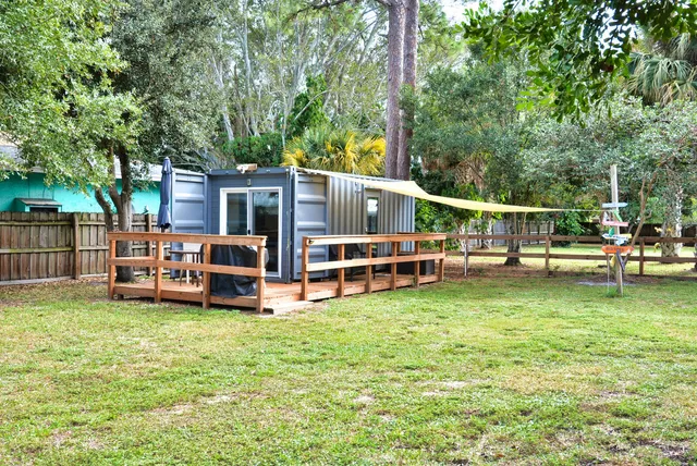 a view of a house with backyard porch and sitting area