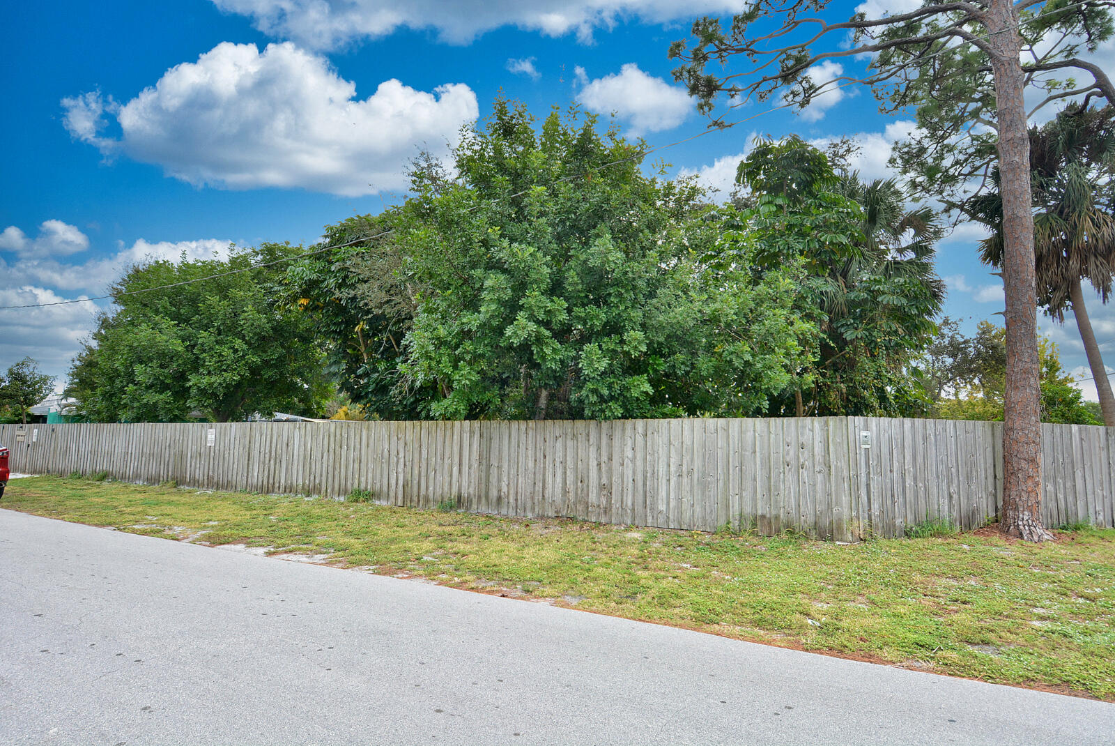 Tbd Southeast Iris Street Stuart, FL 34997 - Photo 32 of 33 a view of a backyard with large tree and wooden fence