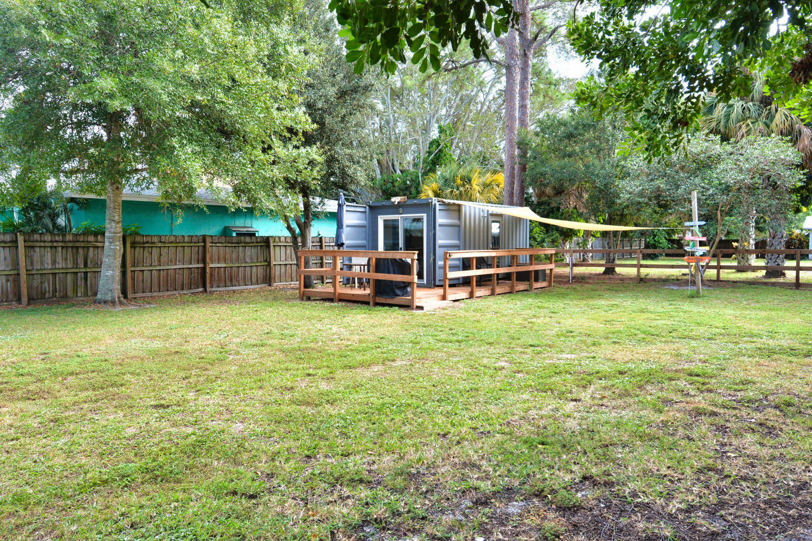 Tbd Southeast Iris Street Stuart, FL 34997 - Photo 6 of 33 a view of a house with a backyard porch and sitting area