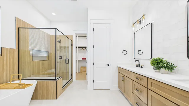 a spacious bathroom with a double vanity sink mirror and shower
