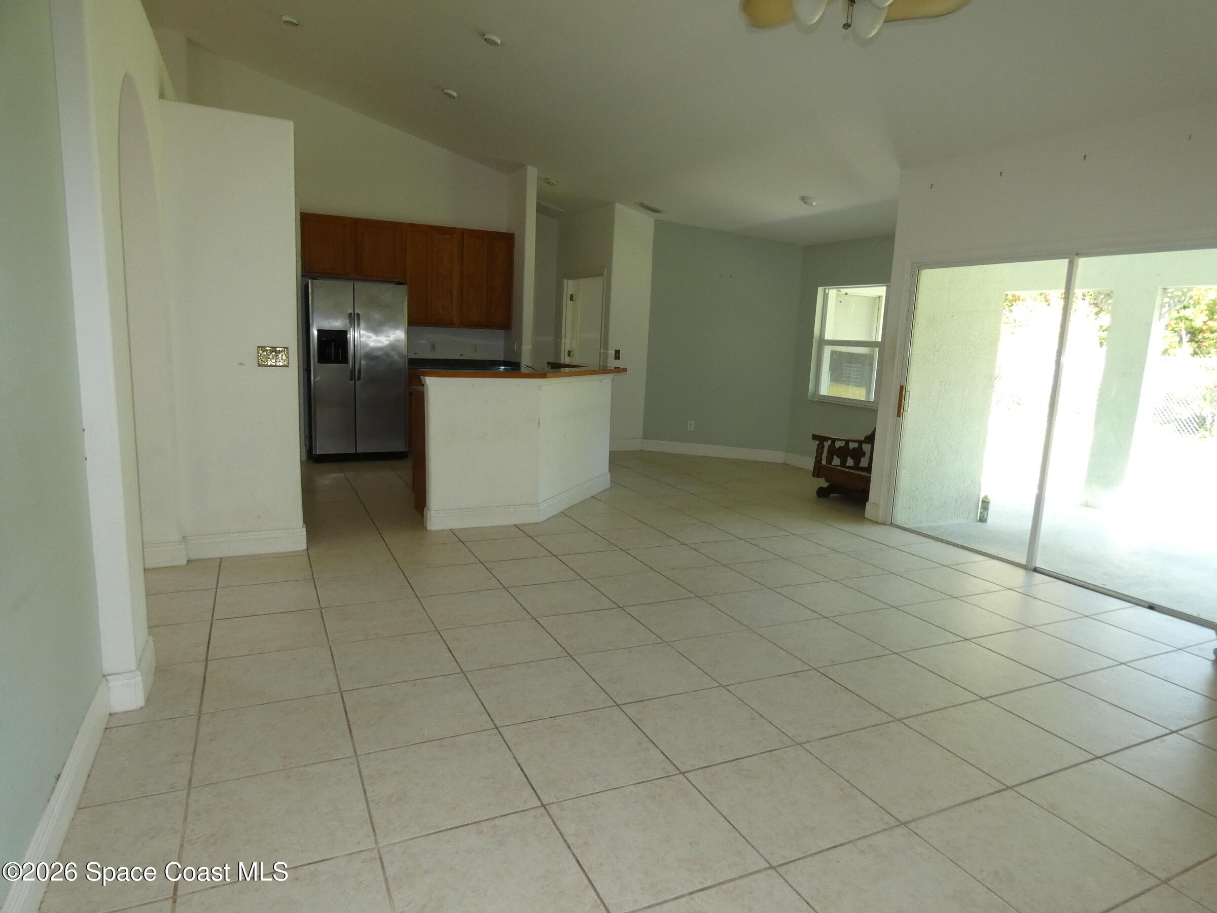 3195 Legendary Lane Melbourne, FL 32935 - Photo 11 of 25 a view of a kitchen with furniture and an empty room
