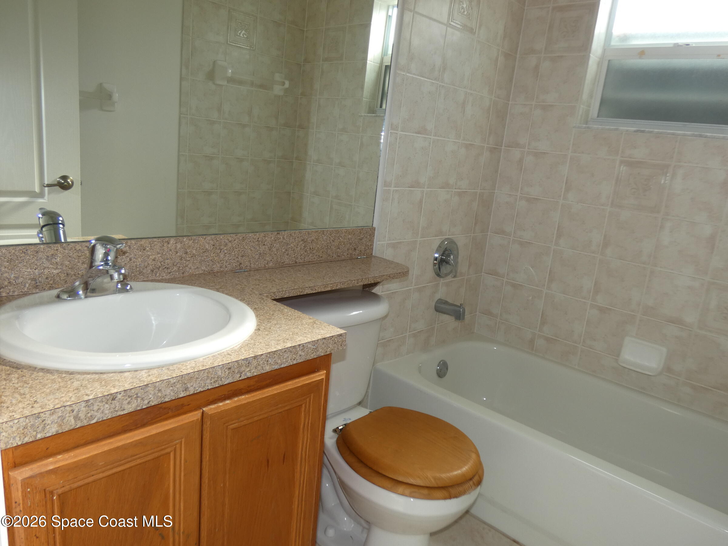 3195 Legendary Lane Melbourne, FL 32935 - Photo 18 of 25 a bathroom with a sink a toilet and a bathtub