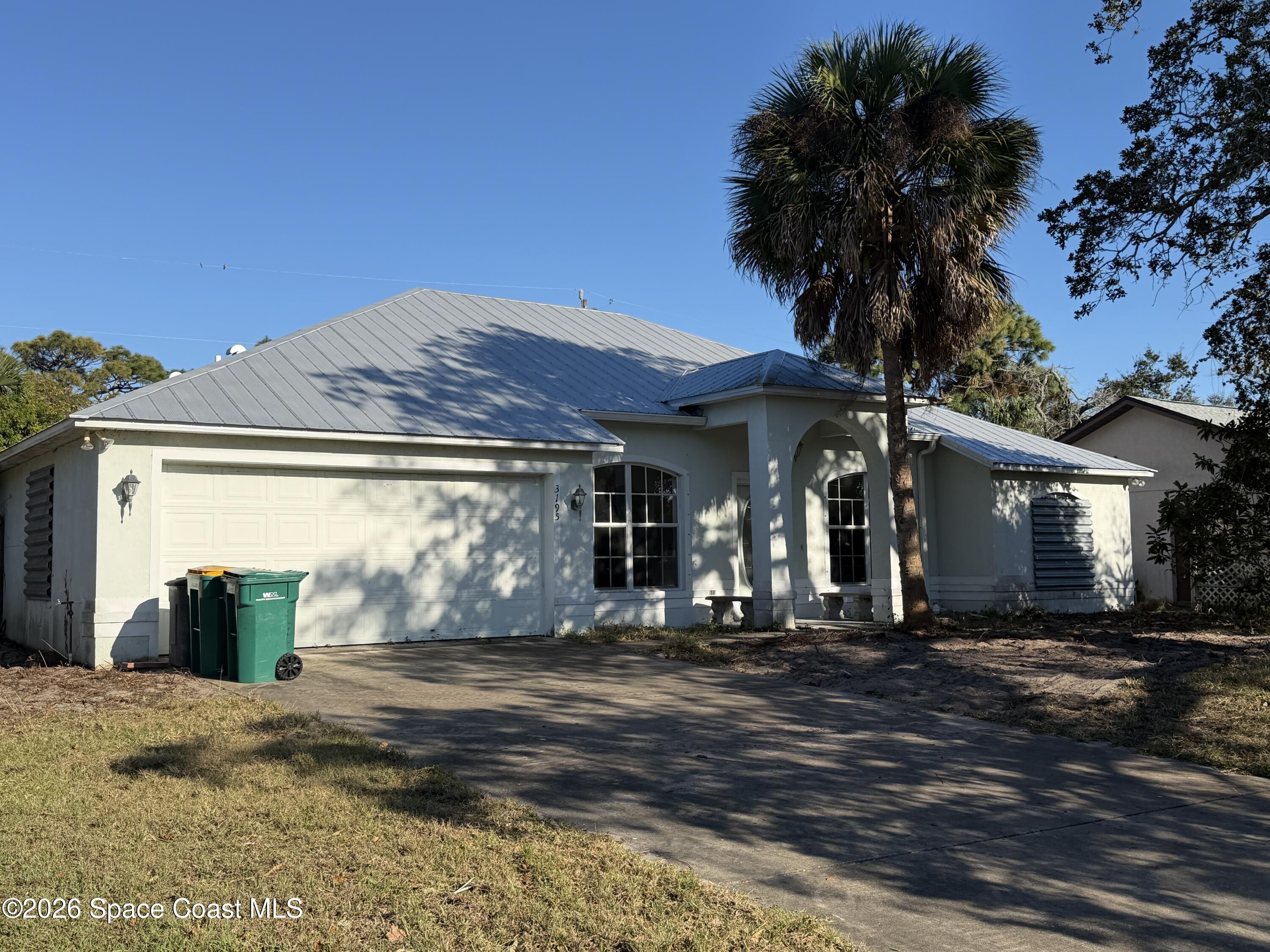 3195 Legendary Lane Melbourne, FL 32935 - Photo 2 of 25 a front view of a house with a yard