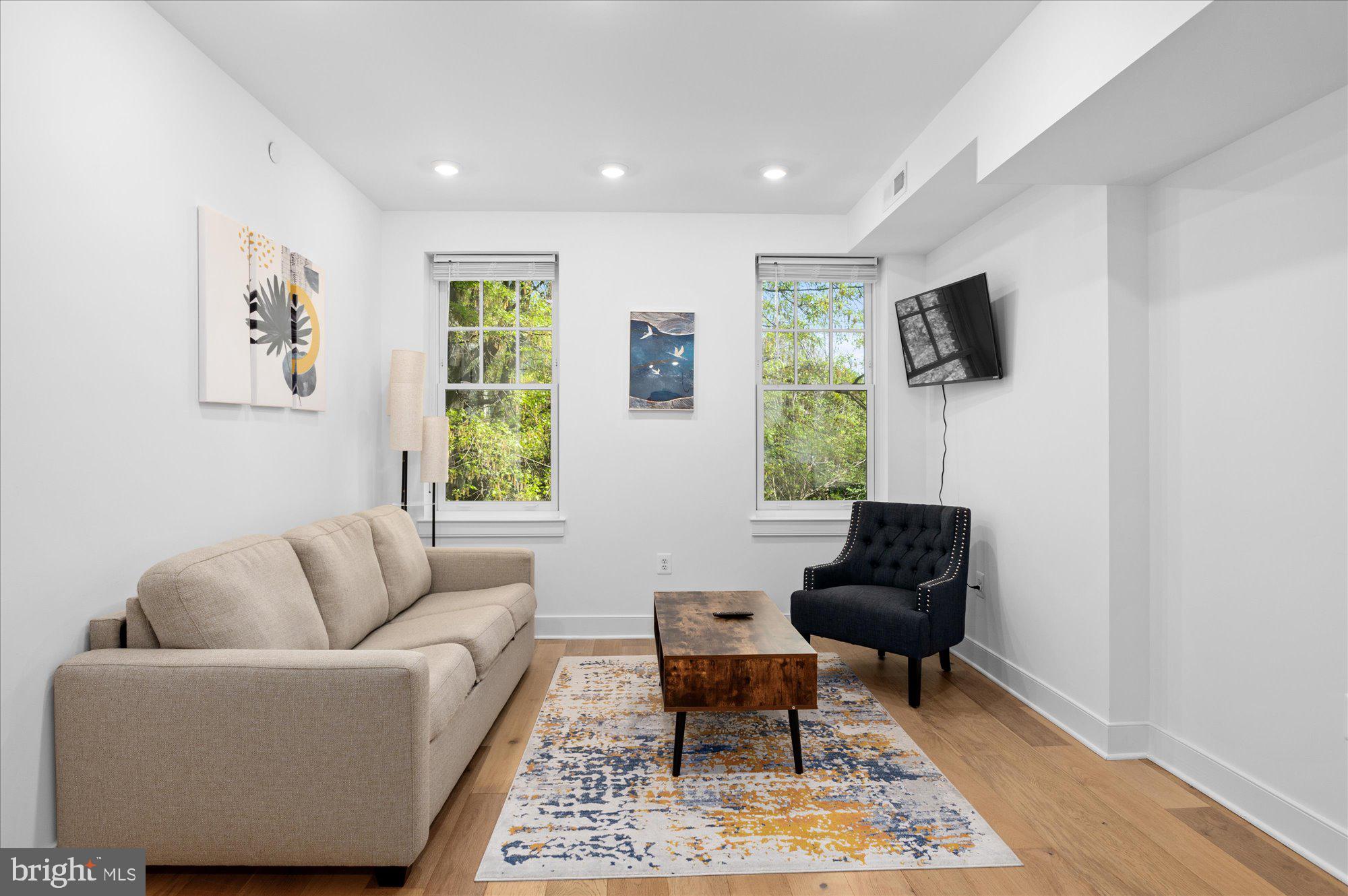 2869 28th Street Northwest, Unit 301 Washington, DC 20008 - Photo 11 of 31 a living room with furniture and a window