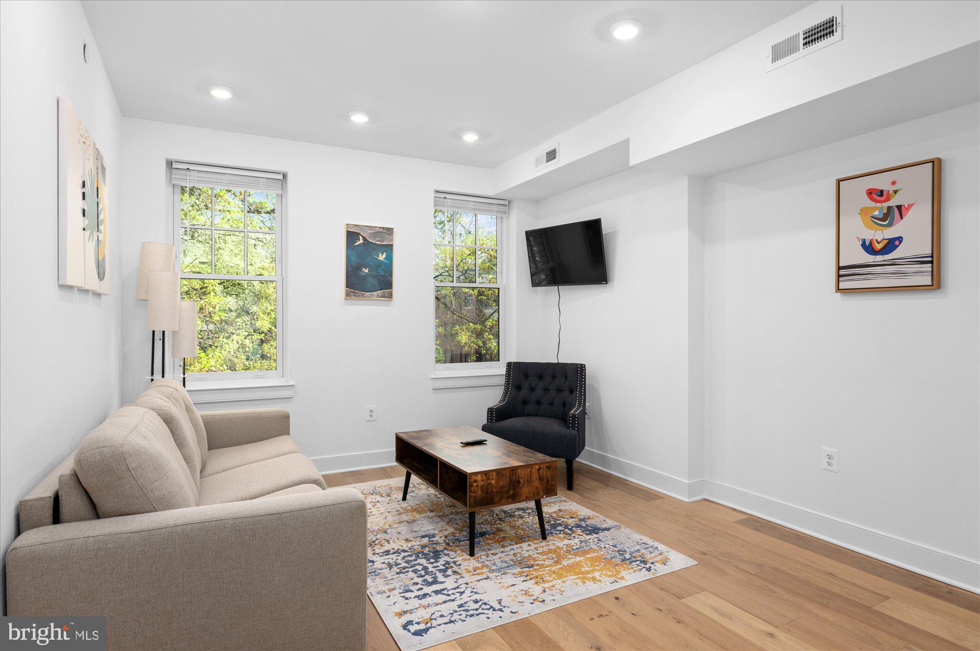 2869 28th Street Northwest, Unit 301 Washington, DC 20008 - Photo 12 of 31 a living room with furniture a rug and a window
