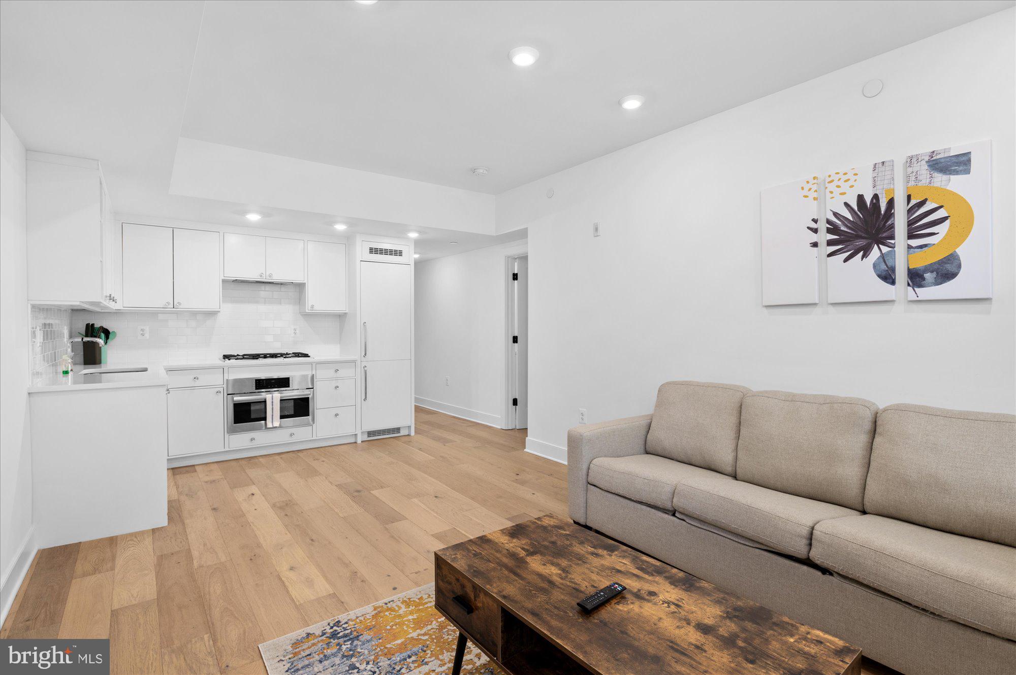 2869 28th Street Northwest, Unit 301 Washington, DC 20008 - Photo 15 of 31 a living room with furniture and kitchen view